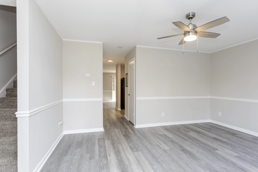 A room with a ceiling fan and light fixture.