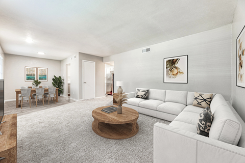A living room with a white couch and a coffee table.