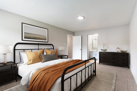 A bedroom with a large bed and a painting on the wall.