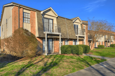 A row of houses with a clear blue sky above them.