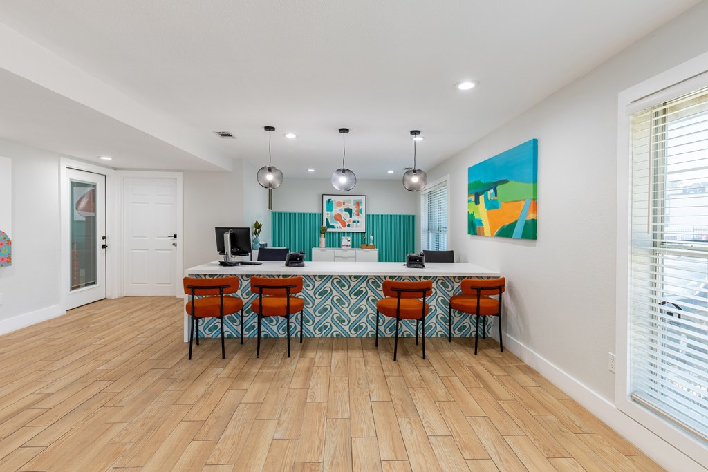 A room with a long table and chairs.