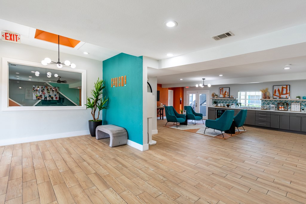 A room with wooden floors and a blue wall with a sign that says "EXIT".
