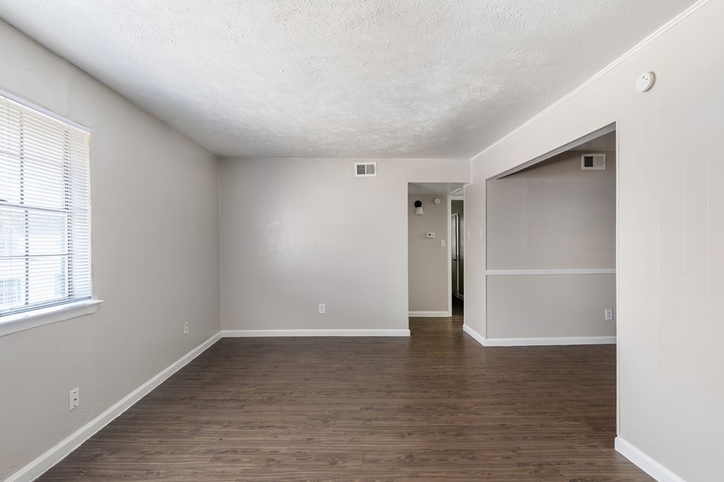 A room with wooden floors and white walls.