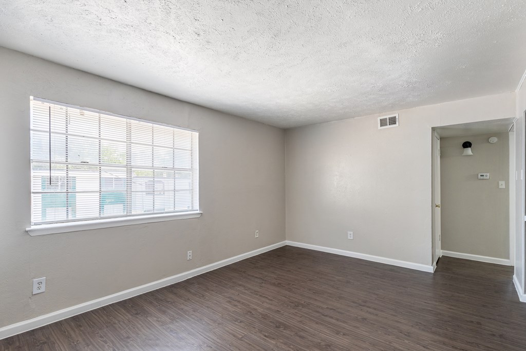 A room with a window and a door.