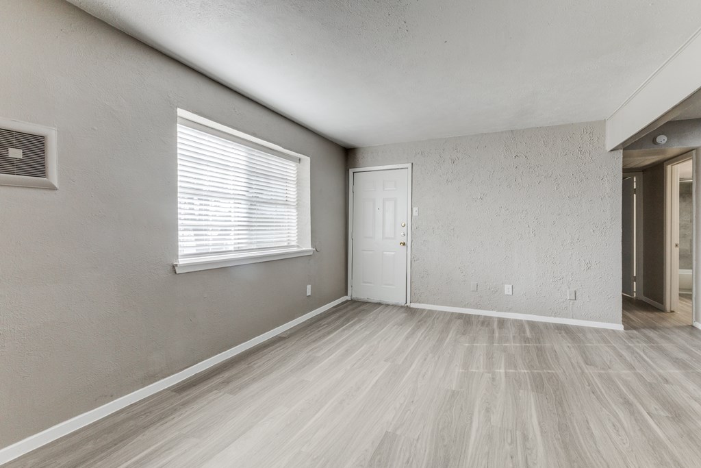 A room with a window and a door.