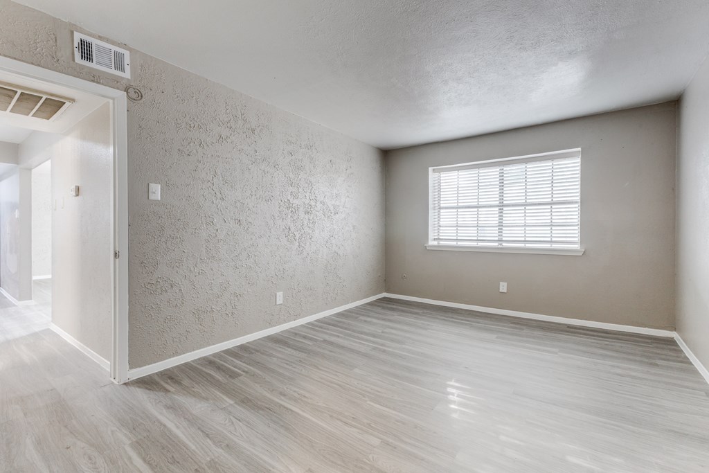 A room with a window and a door.