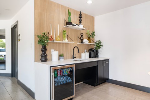 A kitchen with a white counter and a wooden panel on the wall.