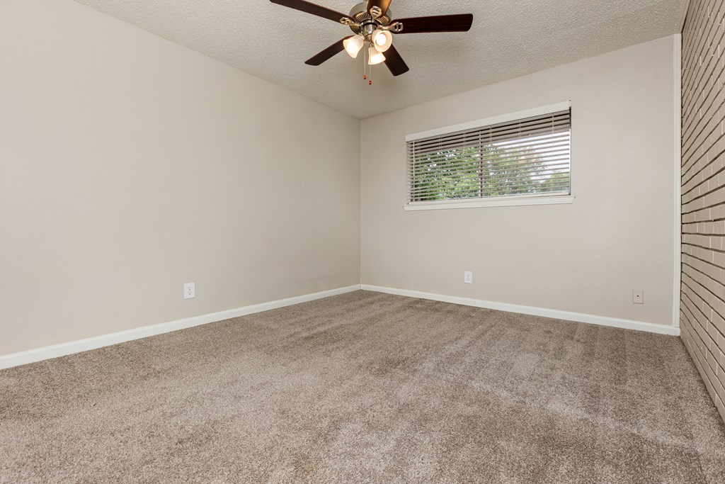 A room with a ceiling fan and a window with blinds. at Lovato, Garland, TX