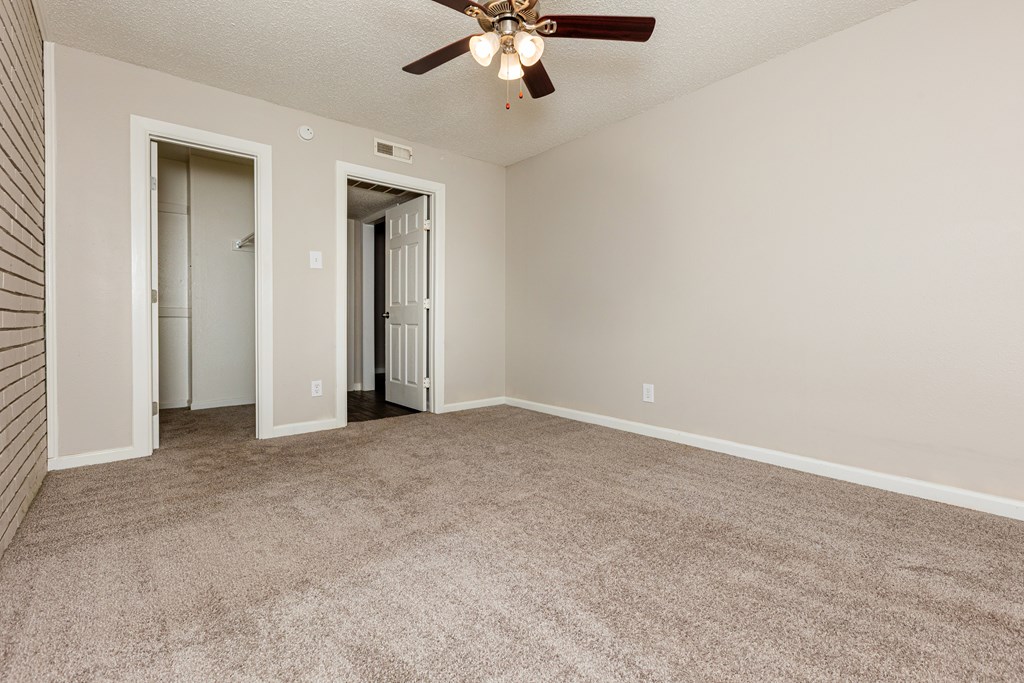 A room with a ceiling fan and carpeted floor. at Lovato, Garland, 75040