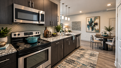 Modern kitchen with stainless steel appliances at Echelon at Monterrey Village Apartments, San Antonio