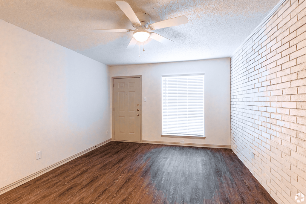 an empty room with hardwood floors and a ceiling fan at Lovato, Texas