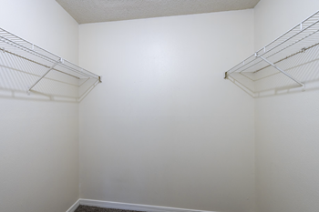 Empty white closet with shelves.