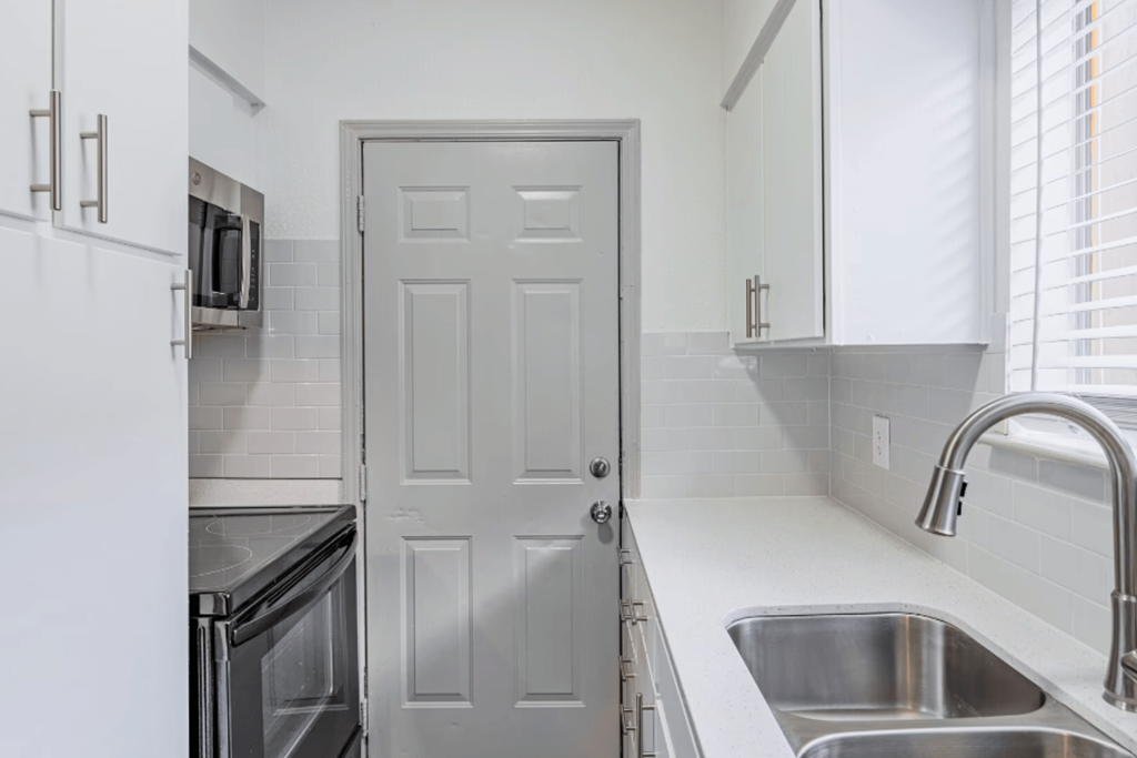 a kitchen with a sink and a door