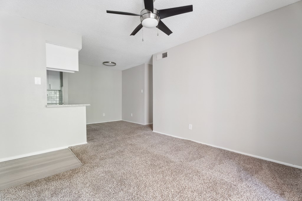 A room with a ceiling fan and carpeted floor. at Anson at North Hills, Raleigh, North Carolina