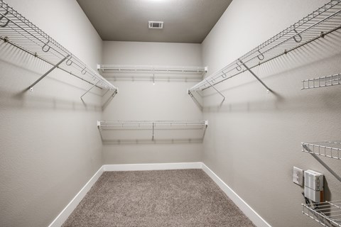 Walk-in closet with wire shelving system at The Watson Apartments, Grand Prairie, Texas