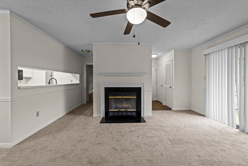 living room with a fireplace and ceiling fan