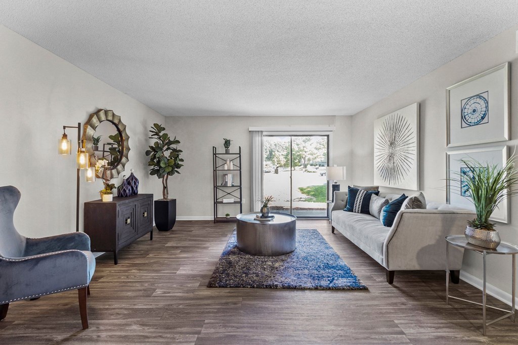 living room with a couch and window at Rosen at North Hills, Raleigh