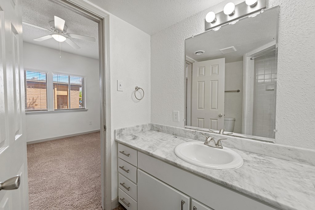 an empty bathroom with a sink and a mirror