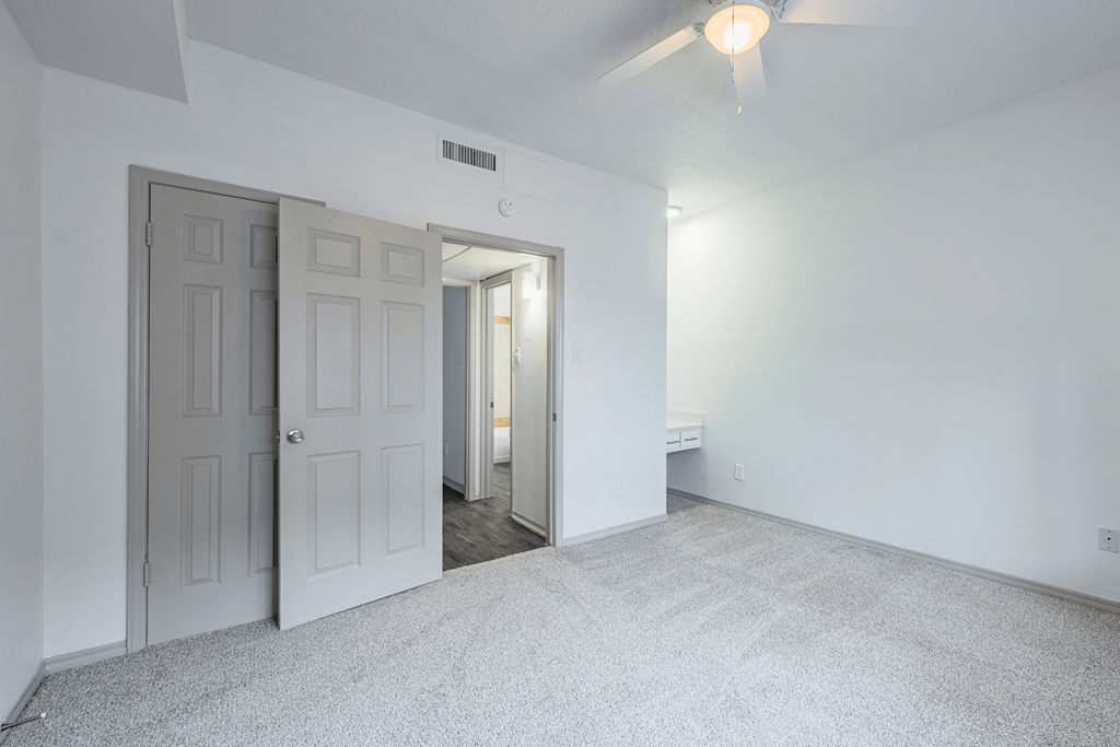 the living room of an empty apartment with white walls and white doors