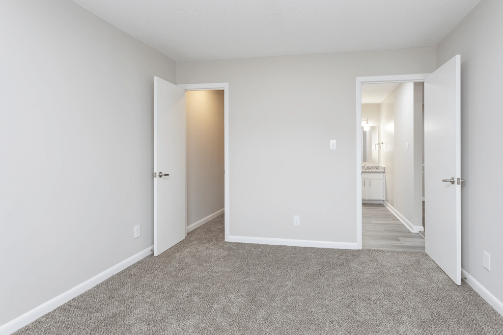 A room with a carpeted floor and white walls.