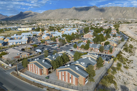 Aerial view of apartment community with mountain backdrop at Las Lomas Apartments, El Paso