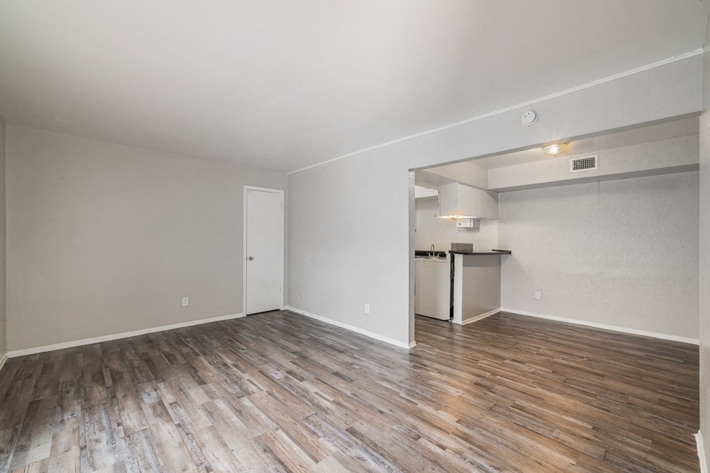 the living room of an apartment with wood flooring and a kitchen the living room of an apartment with wood flooring and a kitchen at Lumina, Texas