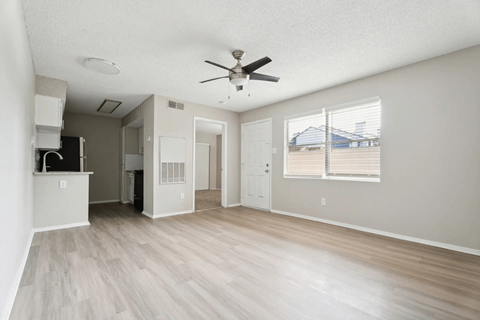 A spacious room with a ceiling fan and light fixture. at Anson at North Hills, Raleigh