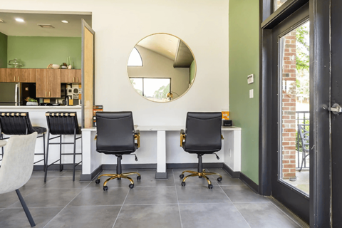 A modern kitchen with a white countertop and black chairs. at Channing, North Carolina
