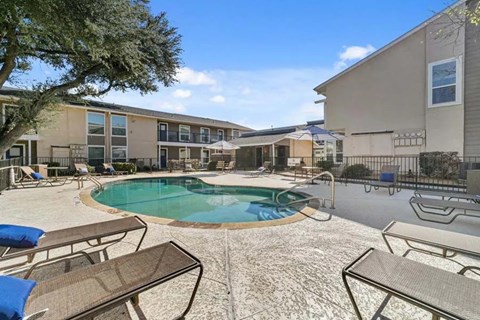 Swimming pool with surrounding deck and lounge chairs at North Creek Apartments, Dallas, 75243