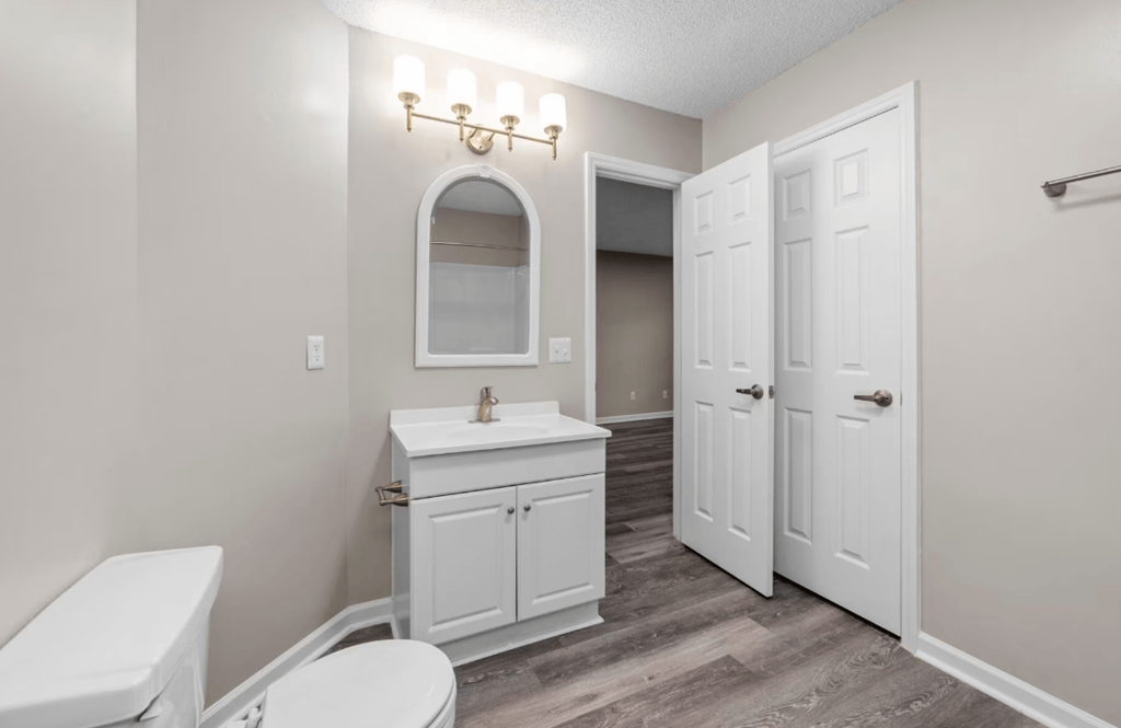 bathroom with faux wood flooring and lighting at Bennett, Greenville, NC, 27858