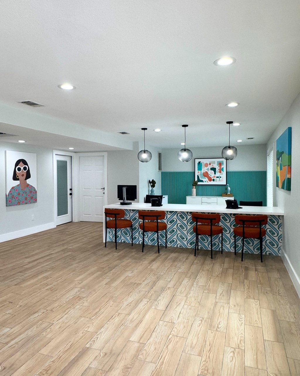 A kitchen with a bar stool and a painting on the wall at Carisma in Richardson, TX