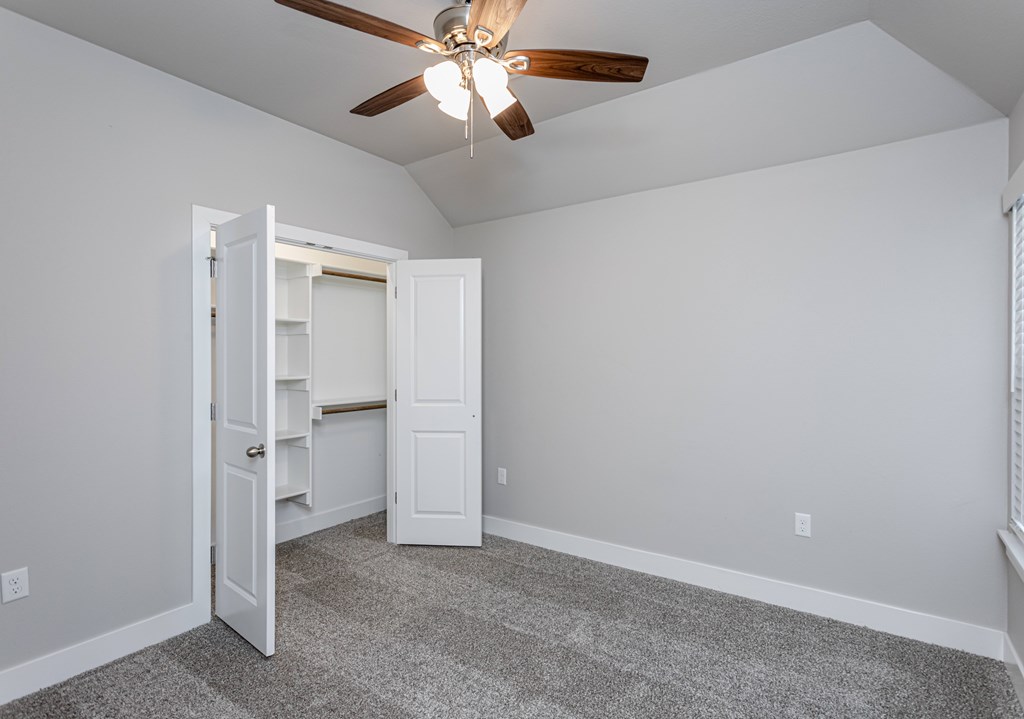 A room with a ceiling fan and a door open to a closet at Cedar Crest Apartments, Arkansas