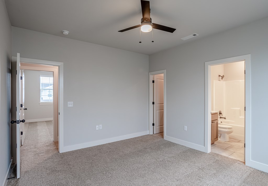 A spacious room with a ceiling fan and carpeted floor at Cedar Crest Apartments, Farmington