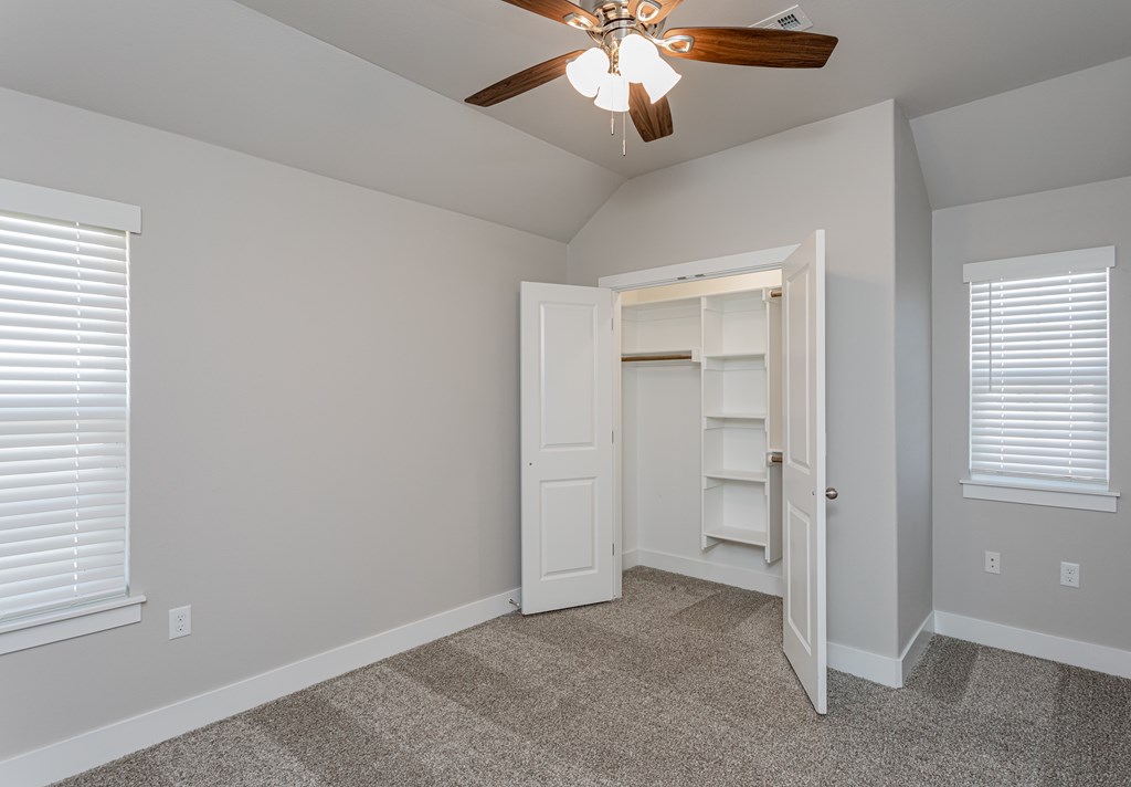 A room with a ceiling fan and a doorway leading to another room at Cedar Crest Apartments, Farmington, Arkansas
