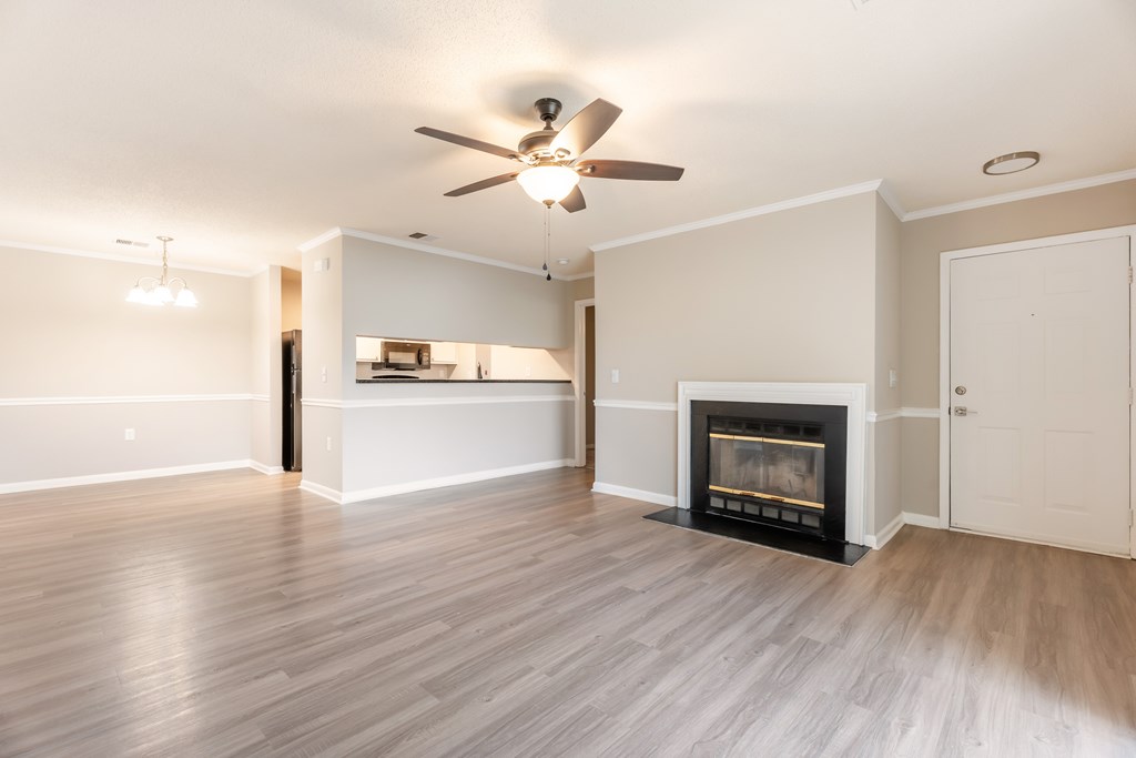 A living room with a fireplace and a ceiling fan. at Rosewood at Colony Square, North Carolina, 27804