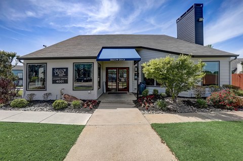 Leasing office exterior with professional landscaping at Shadow Ridge Apartments, Texas