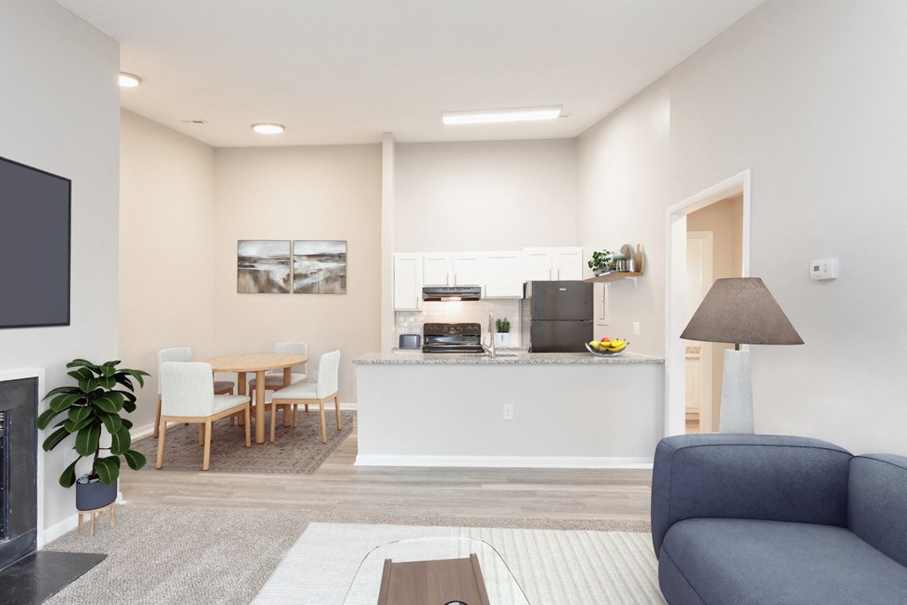 a living room and kitchen with a couch and a table