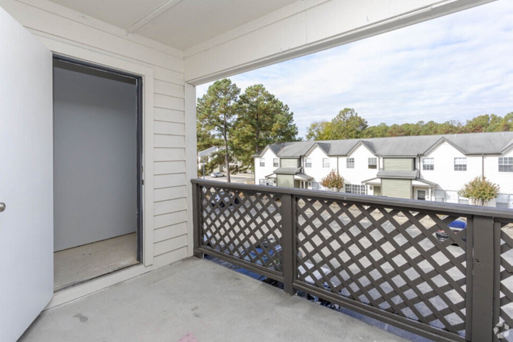 a balcony with a white railing and a view of some apartments  at Henley, North Carolina, 28311