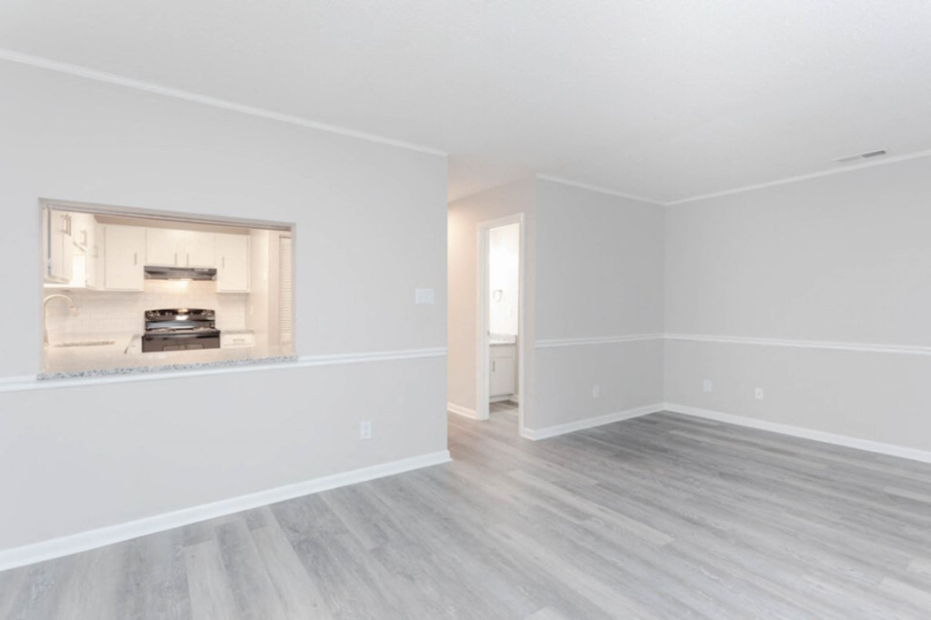 an empty living room with white walls and a fireplace  at Henley, North Carolina, 28311
