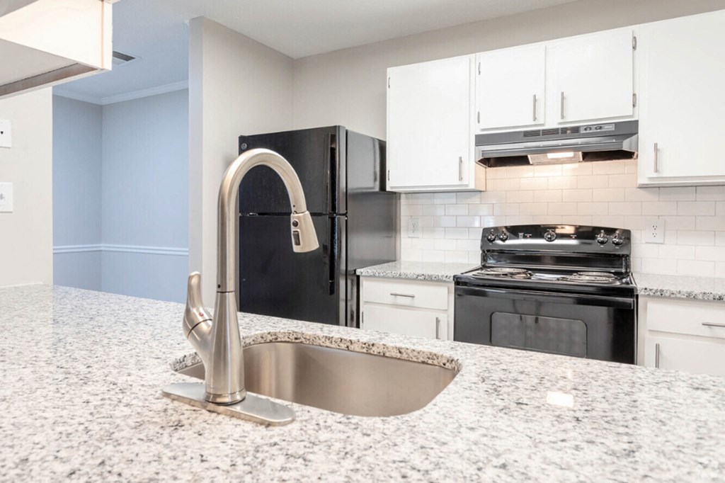 a kitchen with white cabinets and a sink  at Henley, North Carolina