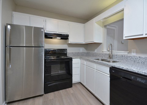 a kitchen with granite counter tops and stainless steel appliances