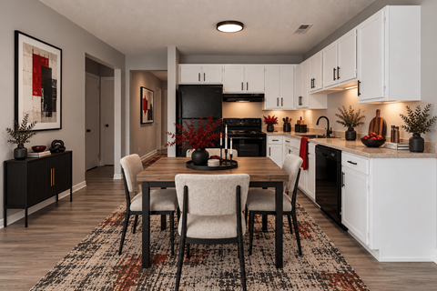 A modern kitchen with a dining table set for four.