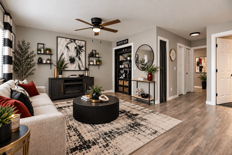 A living room with a fireplace, a couch, and a rug.
