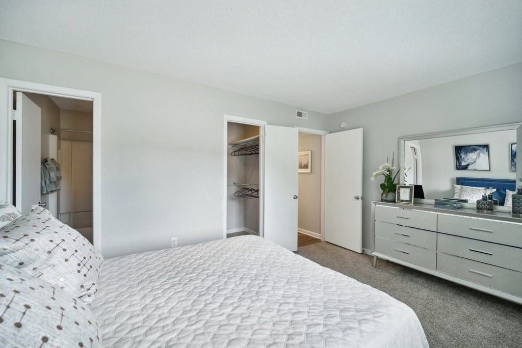 a bedroom with a large bed and a closet