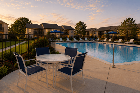 Poolside dining area with seating at dusk at Ridgeview Apartments, Sherman
