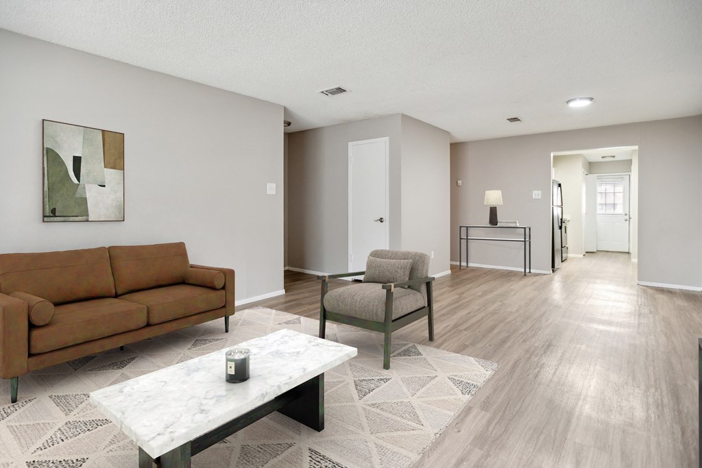 a living room with a couch and chairs and a table