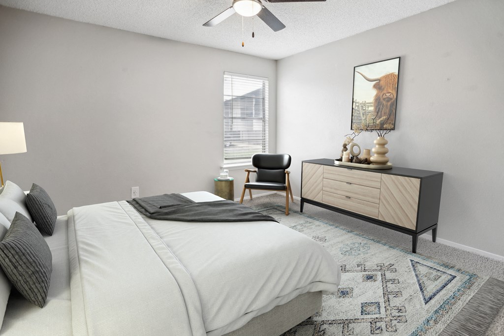 a bedroom with a bed and a dresser and a window