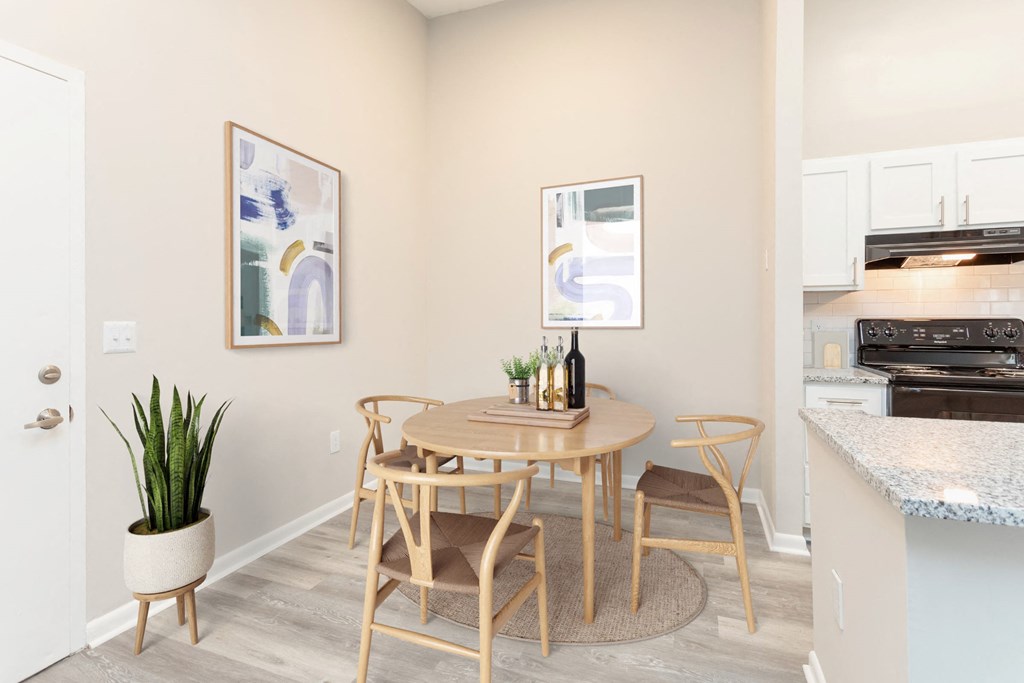a dining room with a table and chairs and a kitchen