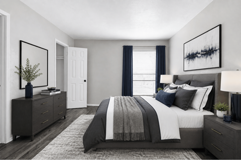 Spacious bedroom with upholstered bed and layered bedding at Ridgeview Apartments, Sherman, 75092