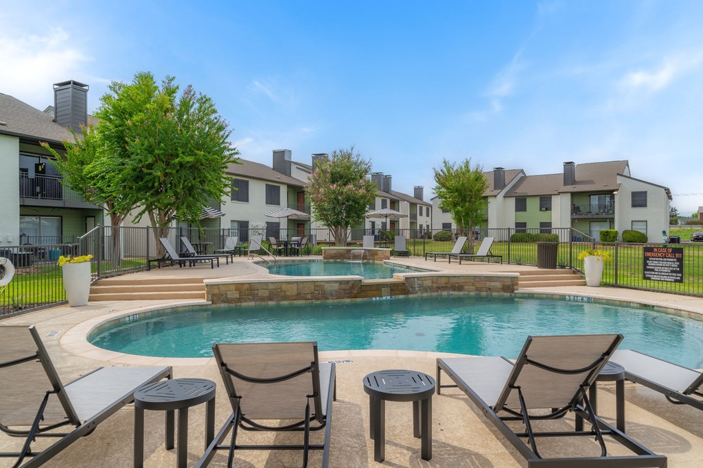 the preserve at ballantyne commons pool with chairs and apartment buildings